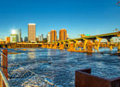 Thumbnail 32 of 37 - a view of a bridge over a river with a city in the background