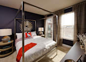 Thumbnail 46 of 64 - a bedroom with a bed and a large window