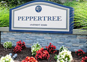 Thumbnail 17 of 17 - A sign for Peppertree Apartment Homes is surrounded by flowers.