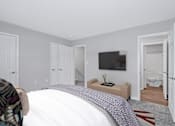Thumbnail 10 of 25 - a bedroom with a tv on the wall