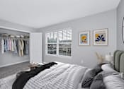Thumbnail 11 of 25 - a bedroom with a large bed and a walk in closet