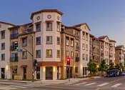Thumbnail 1 of 6 - Casa Salazar apartment building on the corner of a street at dusk