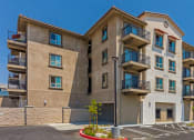 Thumbnail 3 of 6 - a row of apartment buildings with balconies and a parking lot at Casa Salazar