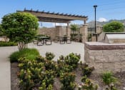 Thumbnail 6 of 6 - a patio with a grill and a table and benches at Casa Salazar Apartments
