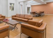 Thumbnail 5 of 6 - Casa Salazar clubhouse with leather couches and chairs and a table