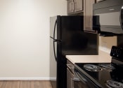 Thumbnail 8 of 12 - an empty kitchen with a sink and a refrigerator