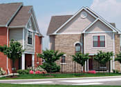 Thumbnail 1 of 5 - Two houses with a red brick and a tan brick with a tree in front of the house.