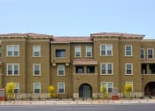 Thumbnail 1 of 6 - a row of apartment buildings on the side of a street