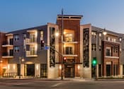 Thumbnail 1 of 10 - Santa Cecilia Apartment building on a city street with a traffic light