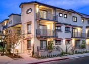 Thumbnail 1 of 6 - a row of apartments with balconies and street lights at Taylor Yard Apartments