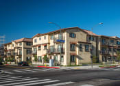 Thumbnail 6 of 6 - Taylor Yard apartment buildings on a city block with a traffic light in frame