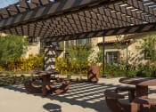 Thumbnail 5 of 6 - a patio with tables and a pergola at Taylor Yard Apartments