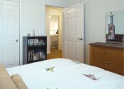 Thumbnail 3 of 6 - a bedroom with a bed and a dresser and a closet