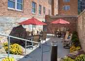 Thumbnail 6 of 6 - a patio with tables and umbrellas at Valentine Apartments