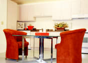 Thumbnail 5 of 6 - a kitchen and dining room with orange chairs and a table at Vista Sunrise Apartments