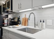 Thumbnail 2 of 40 - a kitchen with a sink and a microwave at Sinclaire on Seminary, Alexandria, VA 22311