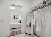 Thumbnail 35 of 40 - a bathroom with a mirror and a closet with robes and a bed at Sinclaire on Seminary, Virginia, 22311
