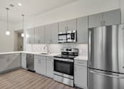 Thumbnail 25 of 40 - a kitchen with stainless steel appliances and white cabinets at Sinclaire on Seminary, Alexandria, 22311