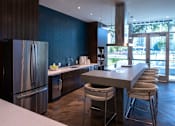 Thumbnail 13 of 40 - a kitchen with stainless steel appliances and a counter with bar stools at Sinclaire on Seminary, Alexandria, VA