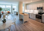 Thumbnail 1 of 40 - a kitchen and dining room with white cabinets and stainless steel appliances at Sinclaire on Seminary, Virginia, 22311