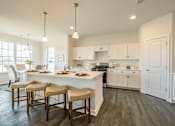 Thumbnail 3 of 20 - Kitchen and dining room with island and recess lighting
