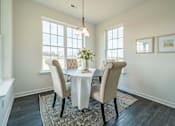 Thumbnail 8 of 20 - Dining area with large windows and natural sunlight