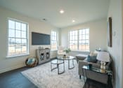Thumbnail 13 of 20 - Living room with large windows and natural night