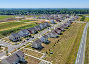 Thumbnail 1 of 23 - A suburban neighborhood with houses and a road.