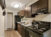 Thumbnail 7 of 35 - A modern kitchen with a stove top oven and a refrigerator. at Sarasota South Apartments, Bradenton, FL, 34207