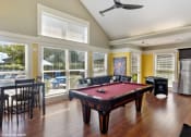 Thumbnail 7 of 20 - a pool table in a living room with windows at Brookstone Village, Cincinnati