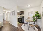 Thumbnail 8 of 35 - A kitchen with a table and chairs in the middle of the room. at Sarasota South Apartments, Florida, 34207