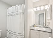 Thumbnail 6 of 43 - Bathroom With Vanity Lights at University Ridge Apartments, Durham, NC, 27707