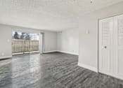 Thumbnail 28 of 45 - A room with a white door and a window with a view of a fence and a building outside at Spyglass Creek, Denver, 80224