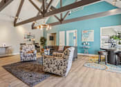Thumbnail 29 of 44 - A living room with a wooden floor and a large mirror on the wall. at Windmill Apartments, Colorado Springs, 80916
