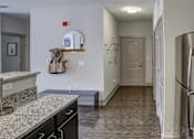 Thumbnail 2 of 21 - Kitchen with granite counter tops and a stainless steel refrigerator at Heritage at Oakley Square, Ohio, 45209