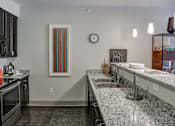 Thumbnail 3 of 21 - Kitchen with granite counter tops and a sink at Heritage at Oakley Square, Ohio, 45209
