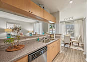 Thumbnail 8 of 117 - A kitchen with a granite counter top and stainless steel appliances. at Heritage Bay, Jensen Beach, FL
