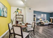 Thumbnail 11 of 36 - Open concept living and dining room with colorful accent walls at The Arbor Walk Apartments, Tampa, 33617