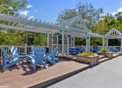 Thumbnail 16 of 20 - a patio with blue chairs and a white pavilion at Brookstone Village, Cincinnati