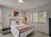 Thumbnail 21 of 50 - Bedroom with a bed and two windows at Governor's Park, Fort Collins, 80525