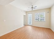 Thumbnail 24 of 64 - A room with a ceiling fan and wooden flooring. at The Dakota, Jupiter, FL, 33458