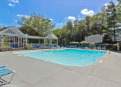 Thumbnail 19 of 20 - a resort style pool with blue chairs around it and a white gazebo at Brookstone Village, Cincinnati