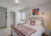 Thumbnail 24 of 50 - Bedroom with a bed, window and closet at Governor's Park, Fort Collins, 80525