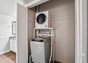 Thumbnail 8 of 40 - A washing machine is in a small room with a door open. at Glen at Lakewood, Colorado, 80228