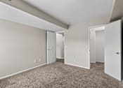 Thumbnail 11 of 57 - Bedroom with a carpeted floor and two doors at Creve Coeur, Creve Coeur, MO