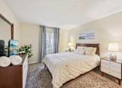 Thumbnail 9 of 35 - A bedroom with a large bed, a nightstand, and a dresser. at Sarasota South Apartments, Bradenton, FL, 34207