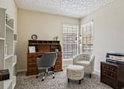 Thumbnail 11 of 39 - A room with a desk, chair, and printer.