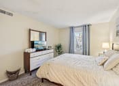 Thumbnail 10 of 35 - A bedroom with a large bed, a dresser, and a mirror. at Sarasota South Apartments, Bradenton, 34207