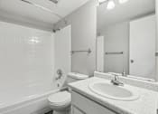 Thumbnail 27 of 45 - A white bathroom with a toilet, sink, and bathtub at Spyglass Creek, Denver, 80224