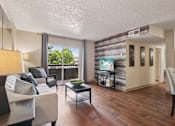 Thumbnail 1 of 35 - Living Room With Balcony at University Village Apartments, Colorado Springs, CO